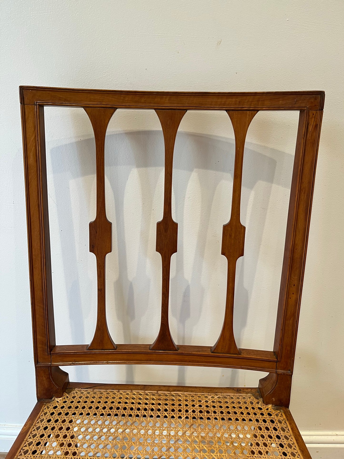 Fine cane-seated chair from Brudenell House, Bucks, in the manner of Gillows.