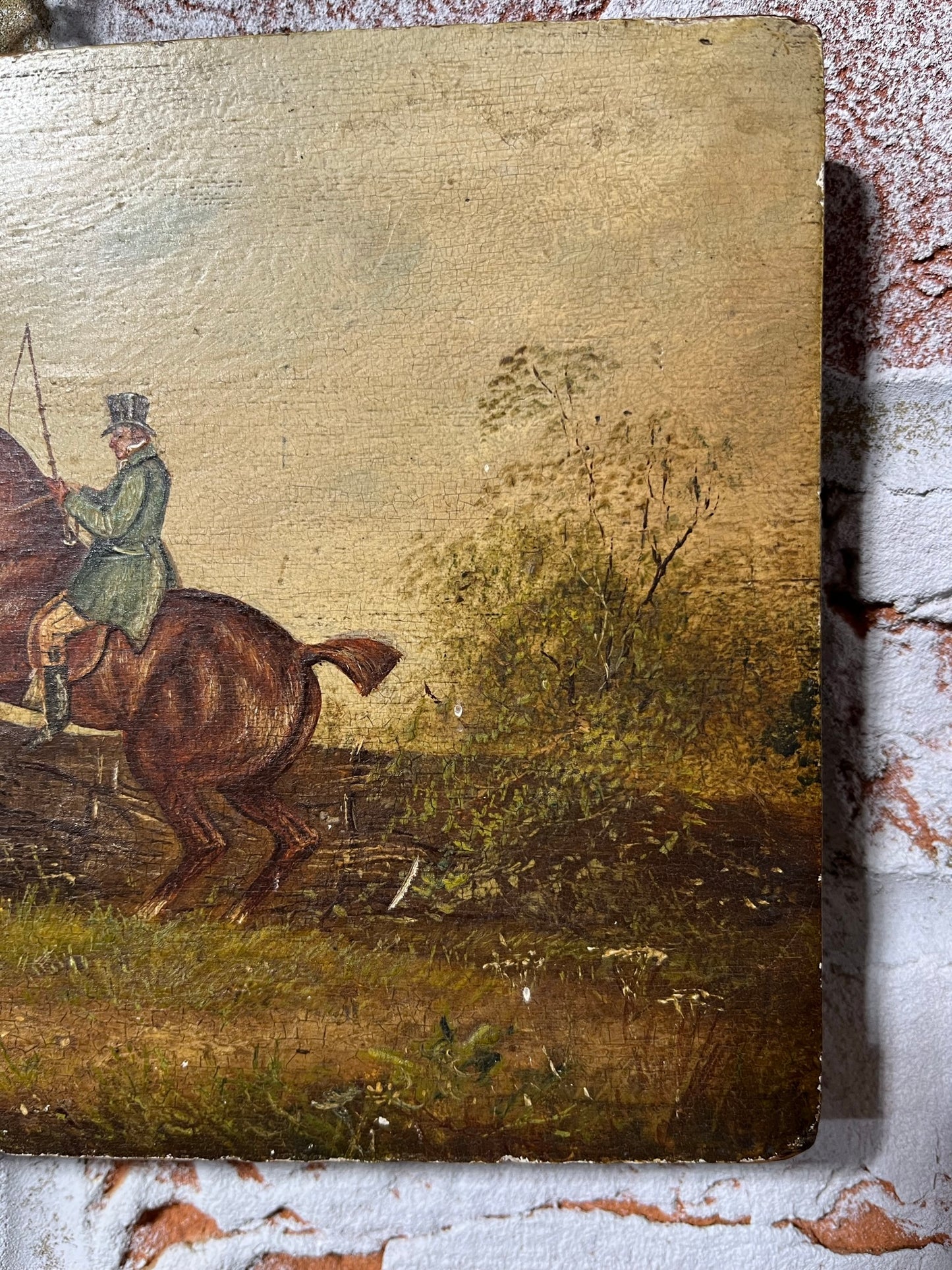 19th century English naive school oil on board of horse and rider taking a fence.