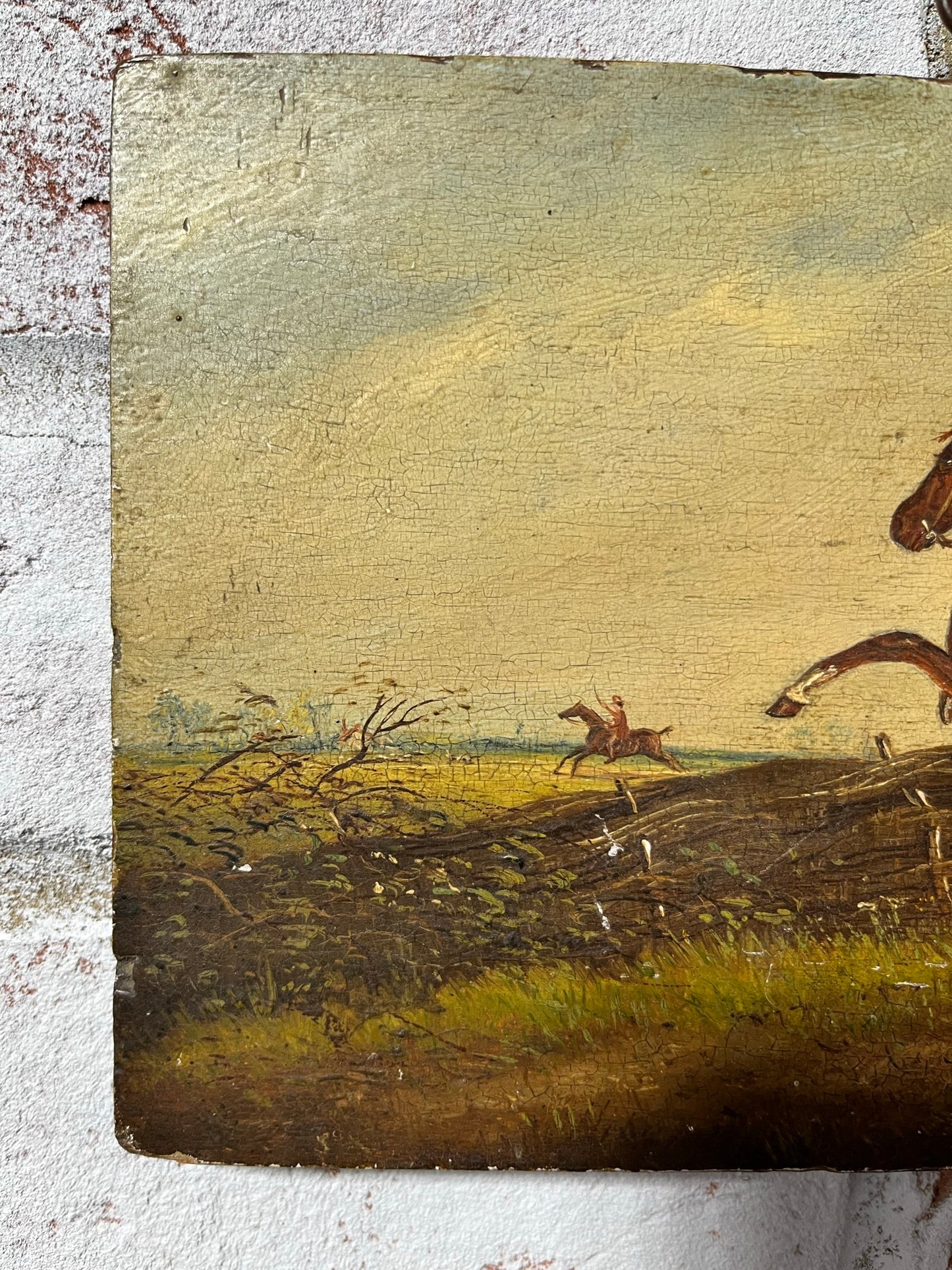 19th century English naive school oil on board of horse and rider taking a fence.