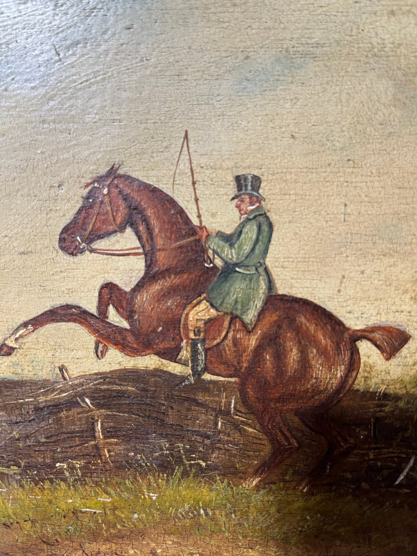 19th century English naive school oil on board of horse and rider taking a fence.