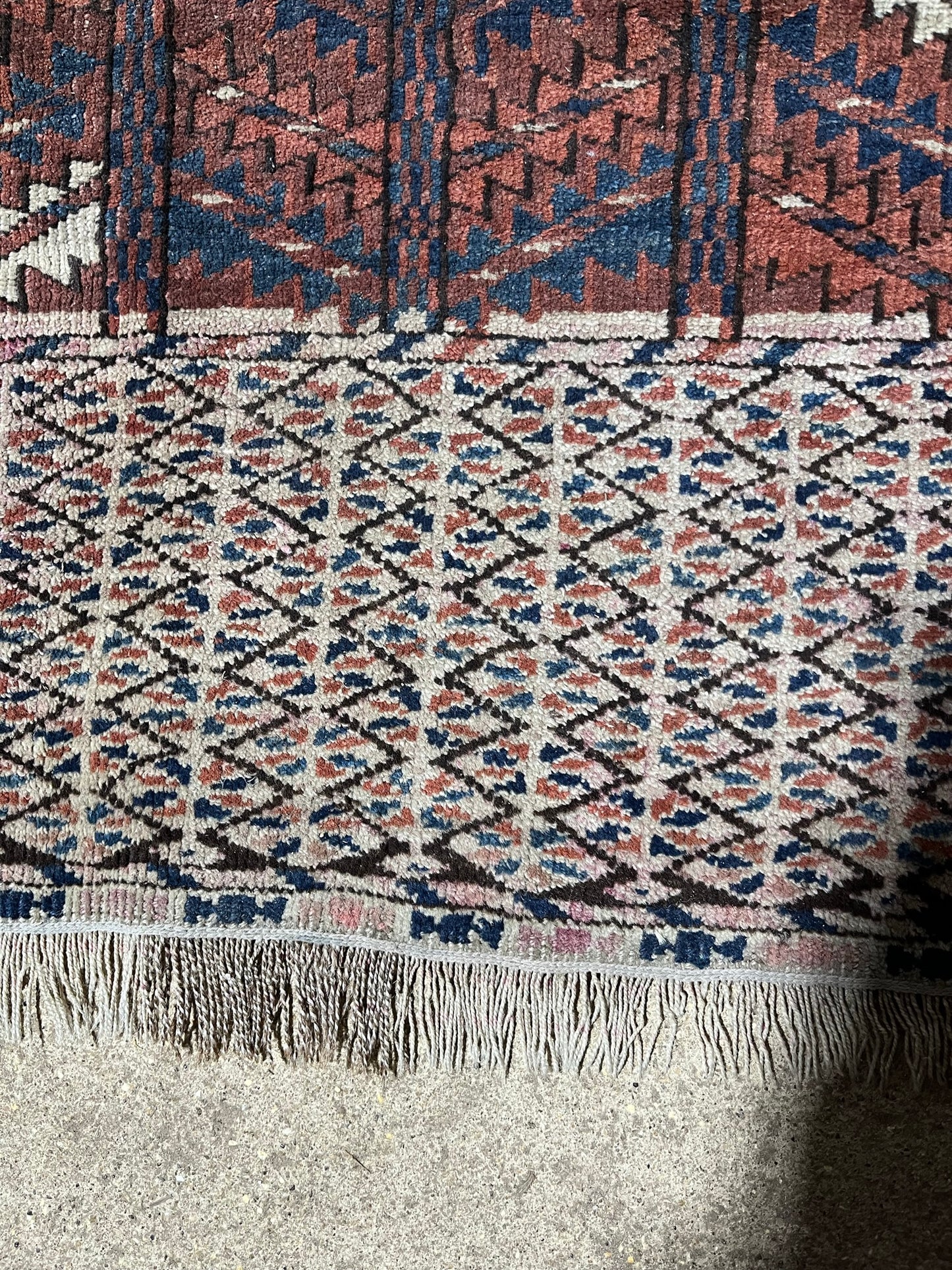 An antique hatchli bokhara rug or door hanging.