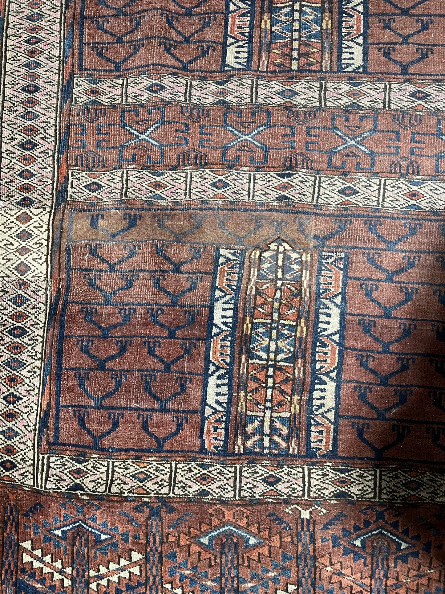 An antique hatchli bokhara rug or door hanging.