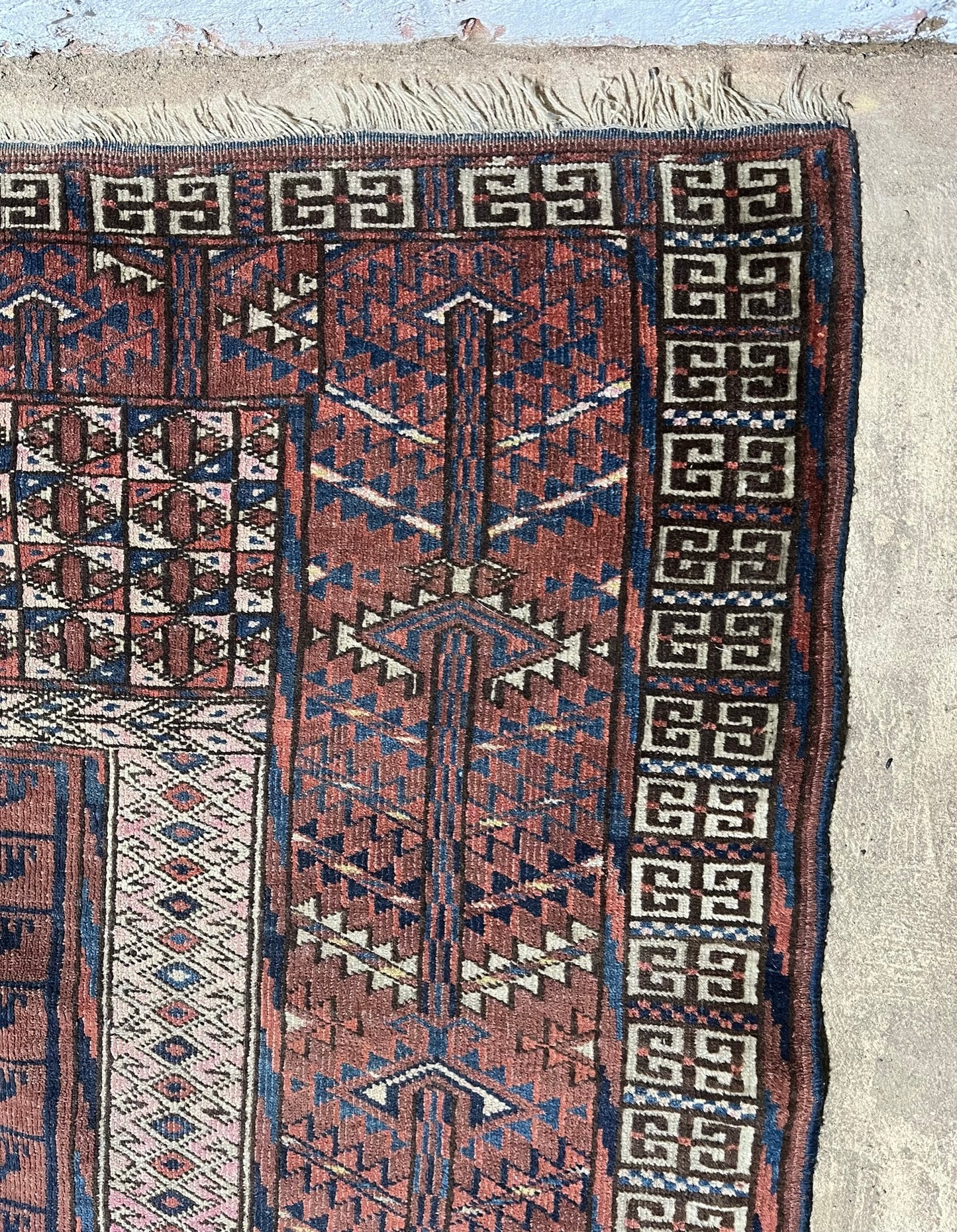 An antique hatchli bokhara rug or door hanging.
