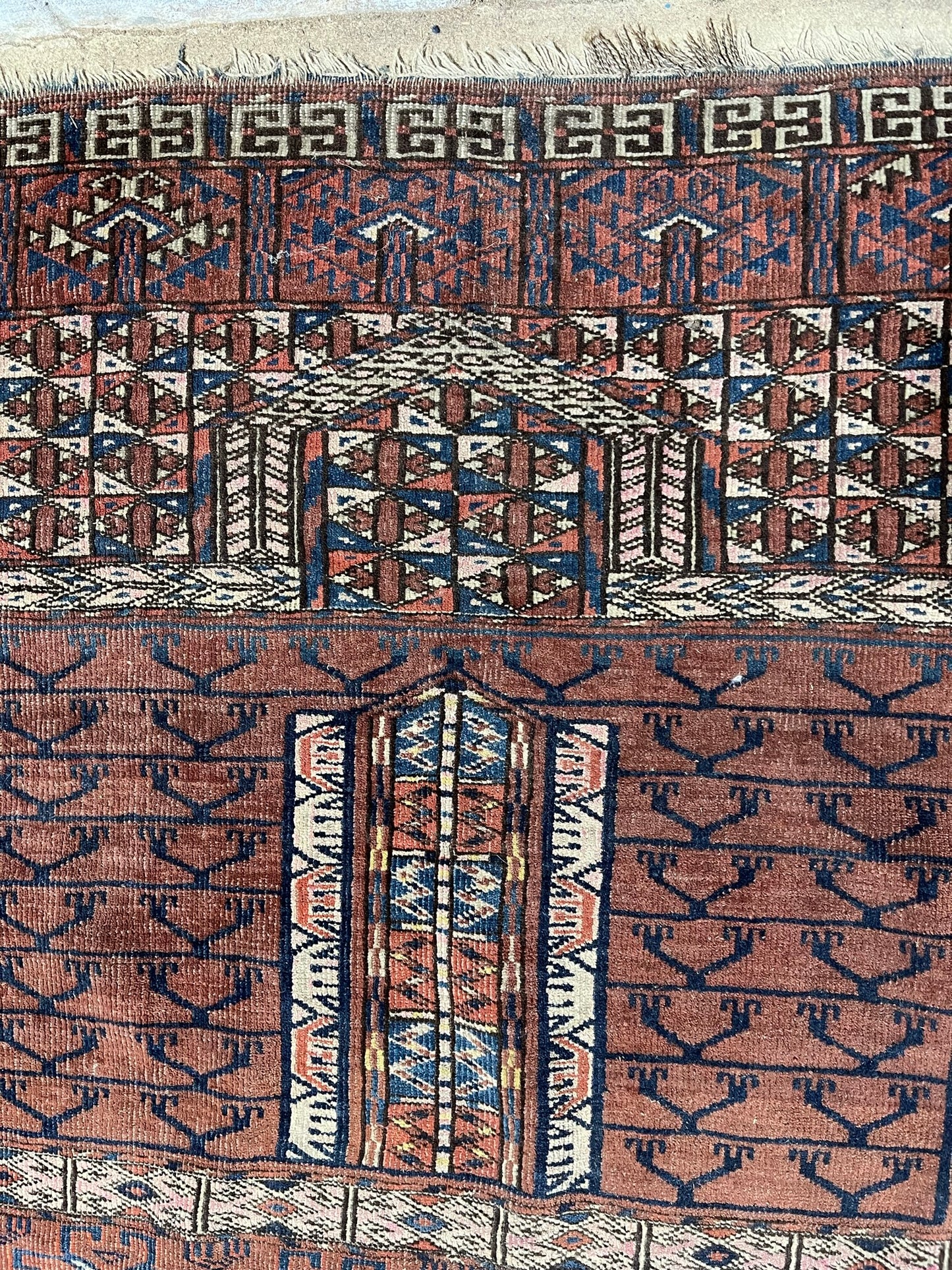 An antique hatchli bokhara rug or door hanging.