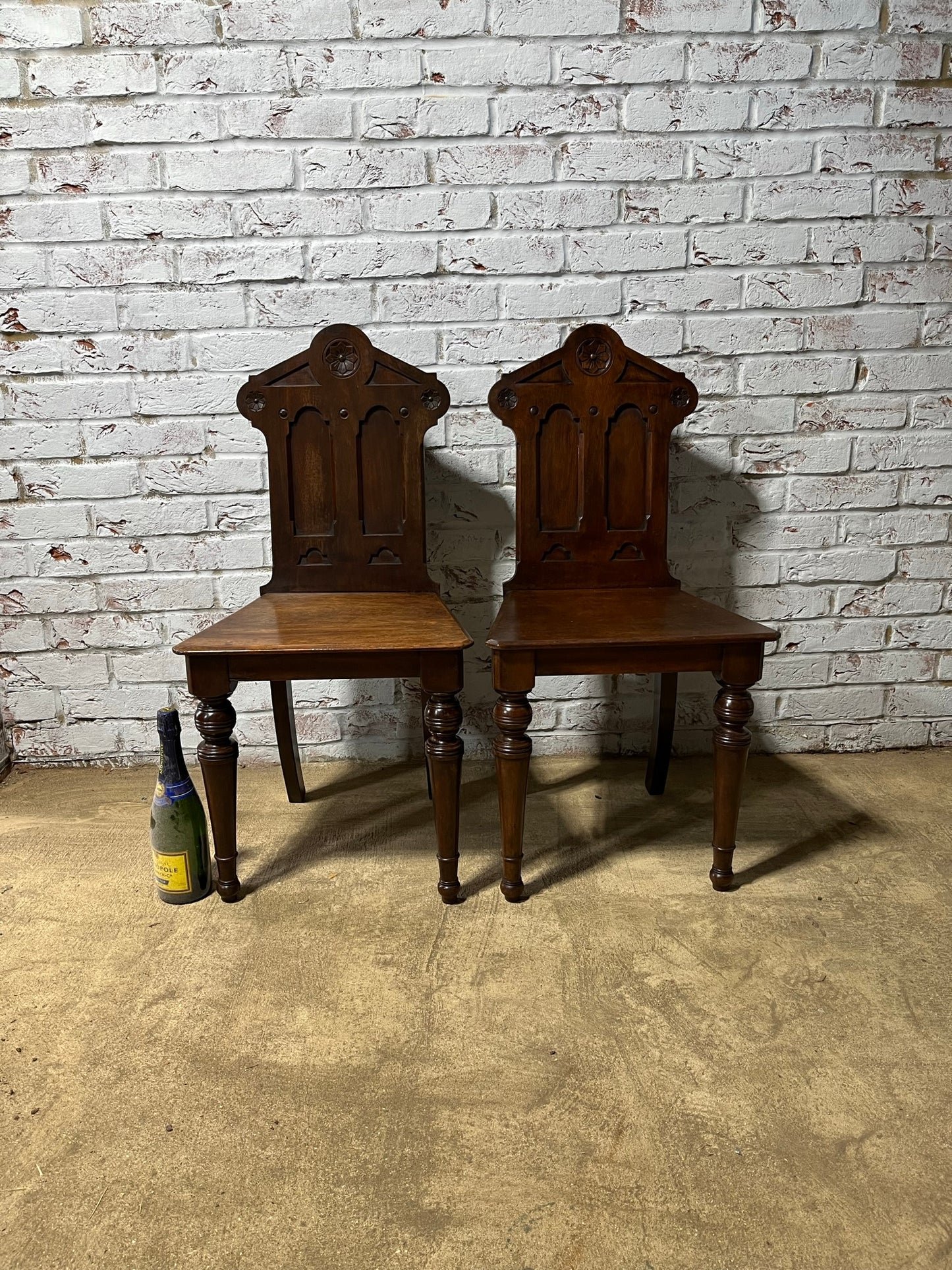 A pair of Gothic hall chairs.