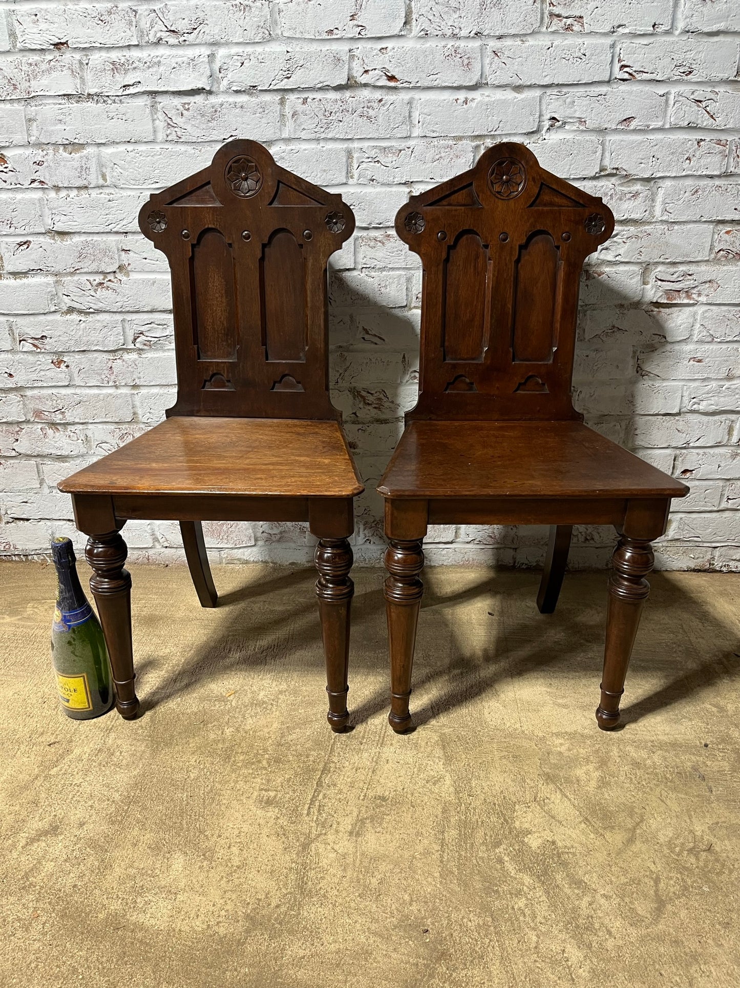 A pair of Gothic hall chairs.