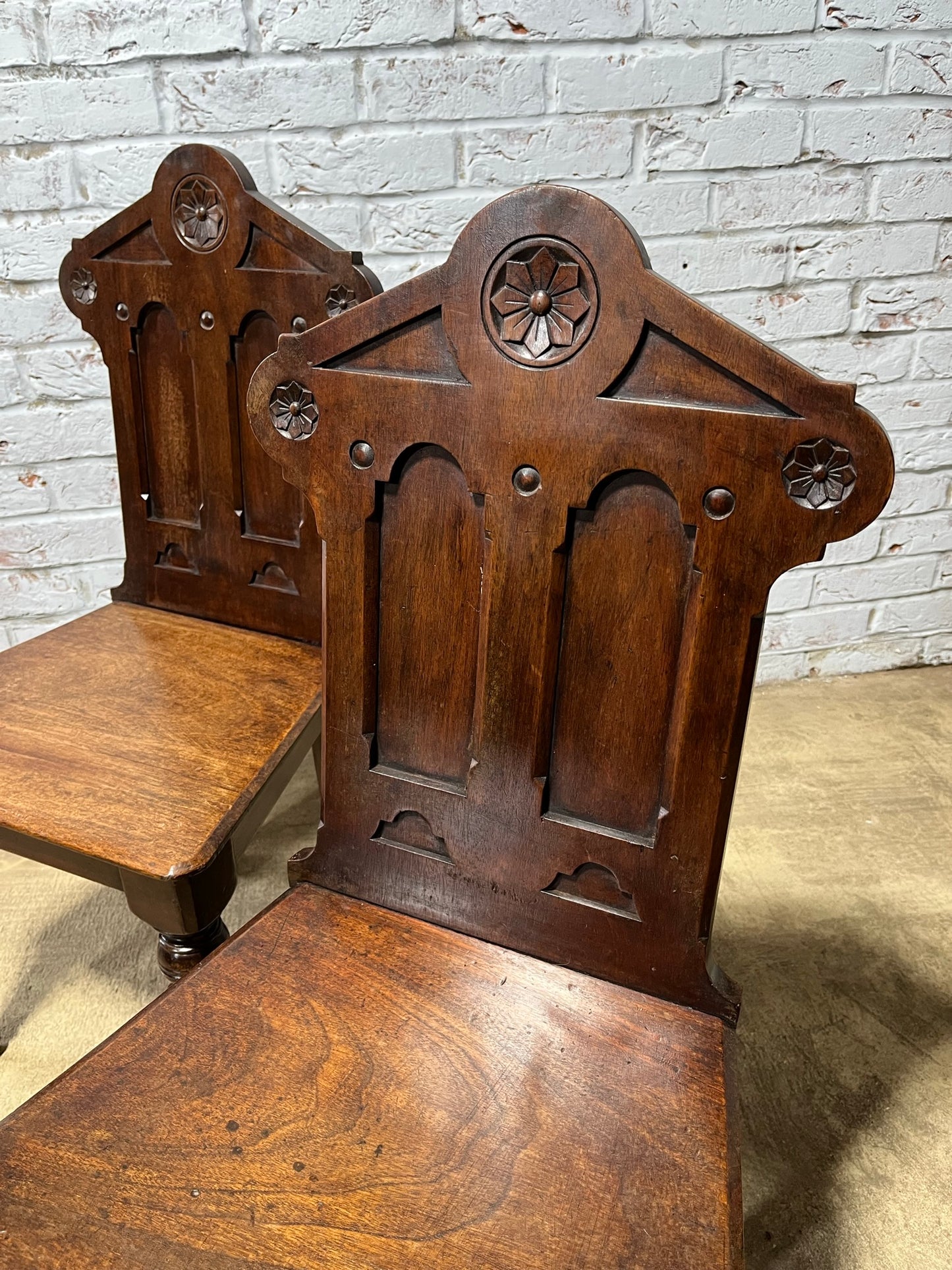 A pair of Gothic hall chairs.