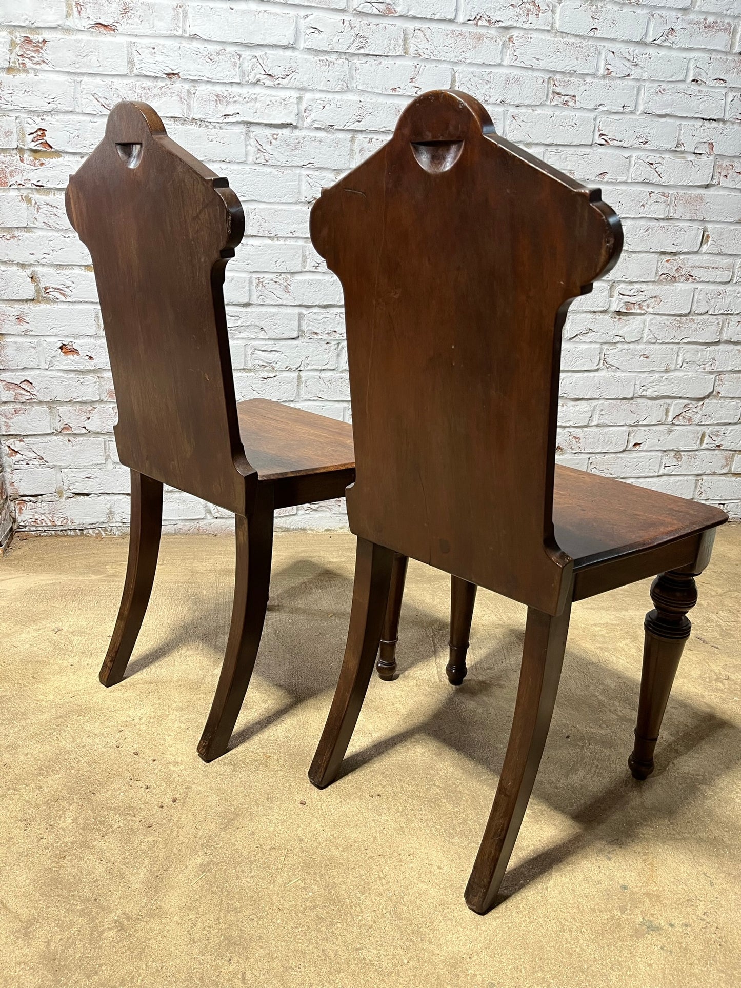 A pair of Gothic hall chairs.