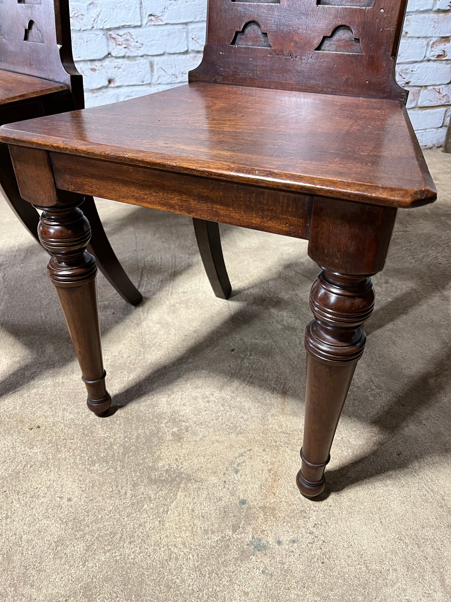 A pair of Gothic hall chairs.