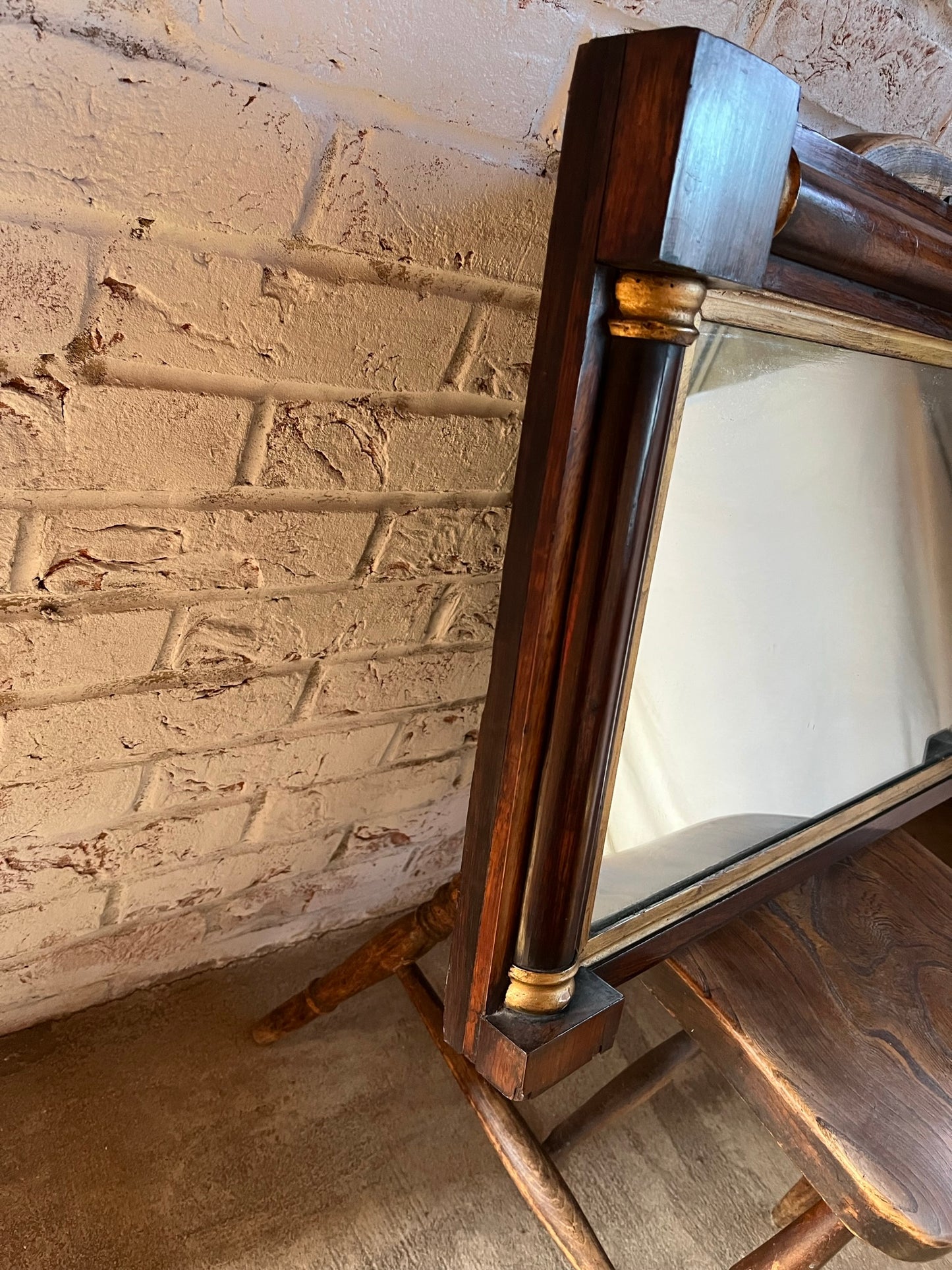 Regency rosewood and gilt overmantle or wall mirror.