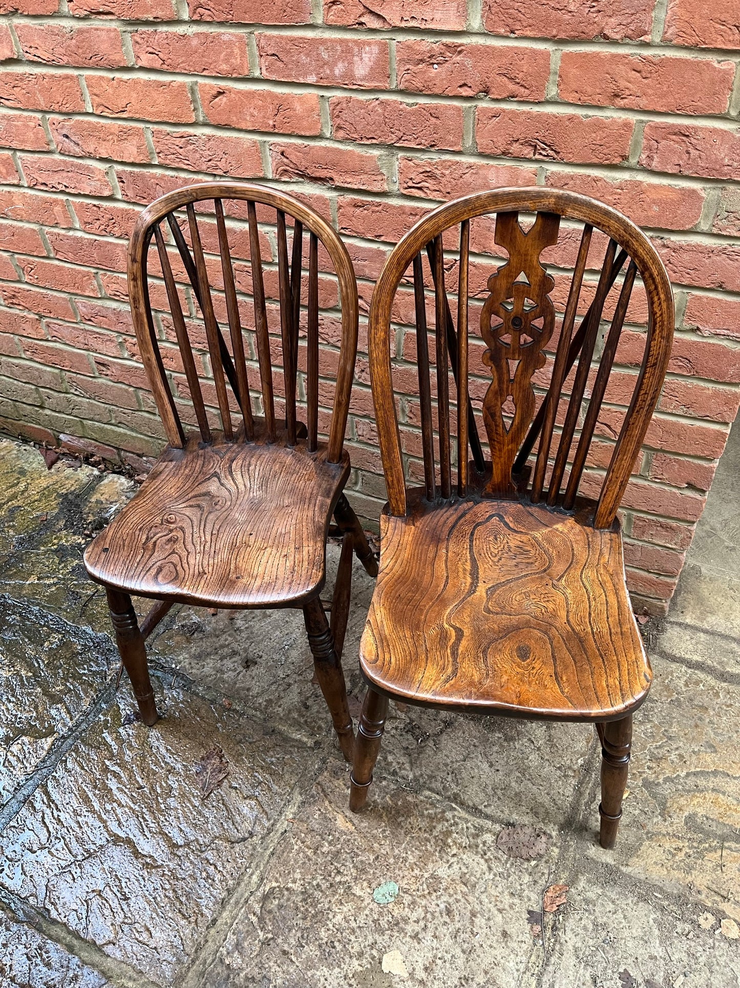 Two 19th century wheel back/stick back kitchen or dining chairs.