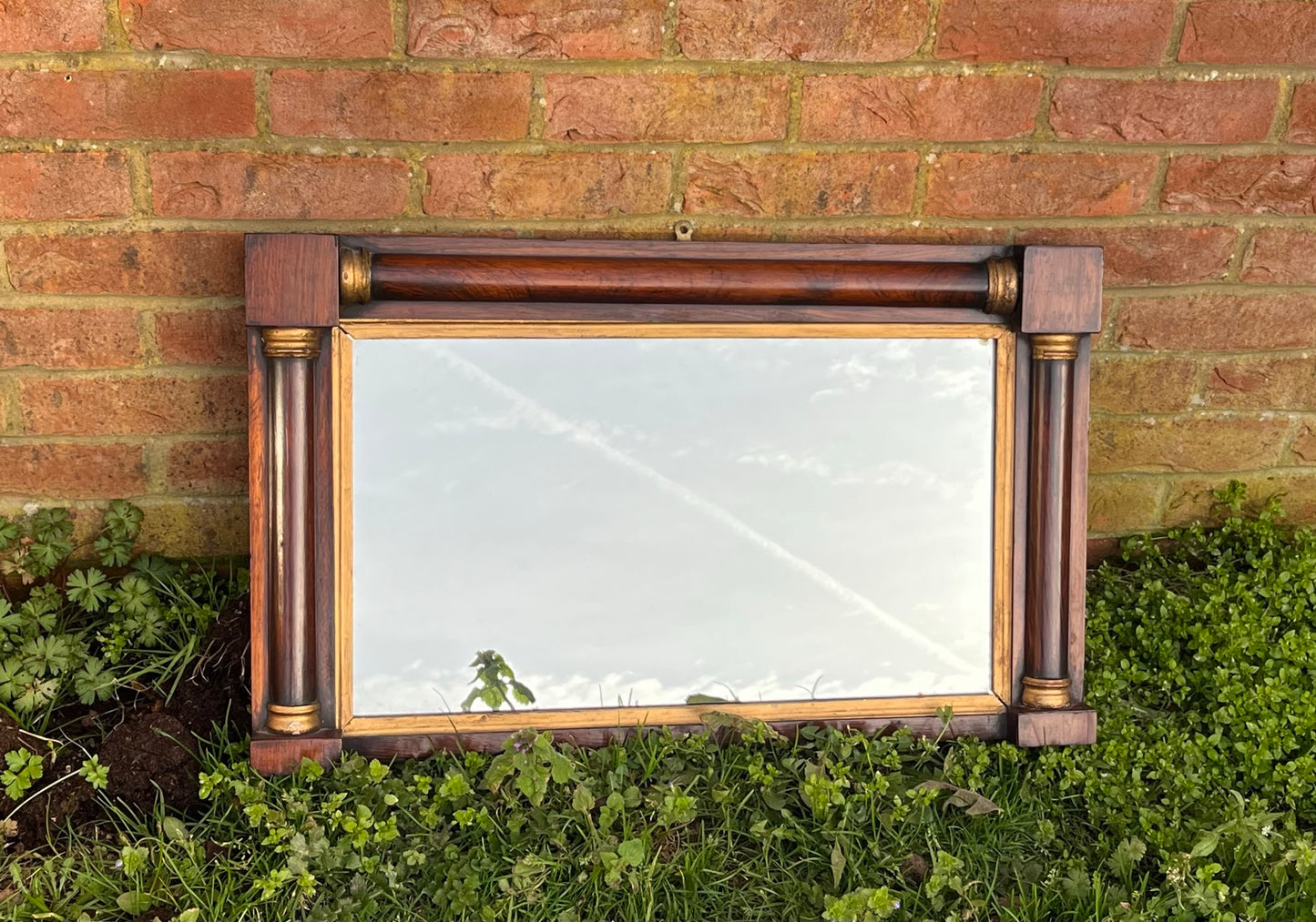 Regency rosewood and gilt overmantle or wall mirror.