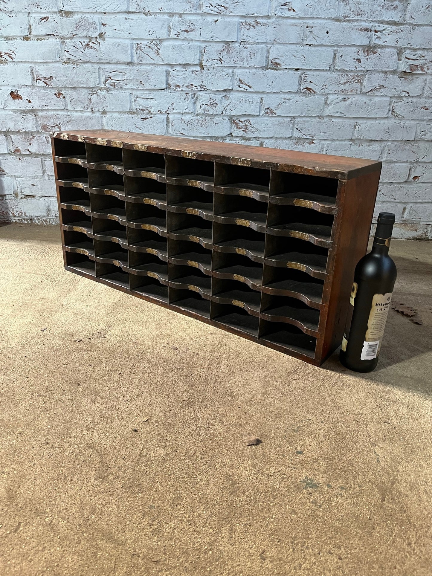 A vintage pine and metal industrial pigeon hole cabinet.