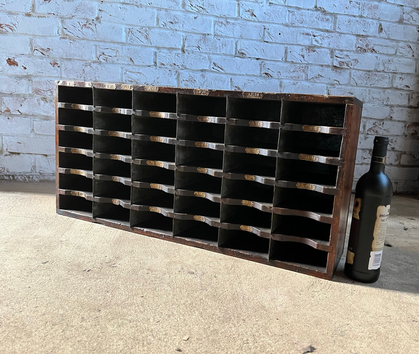 A vintage pine and metal industrial pigeon hole cabinet.
