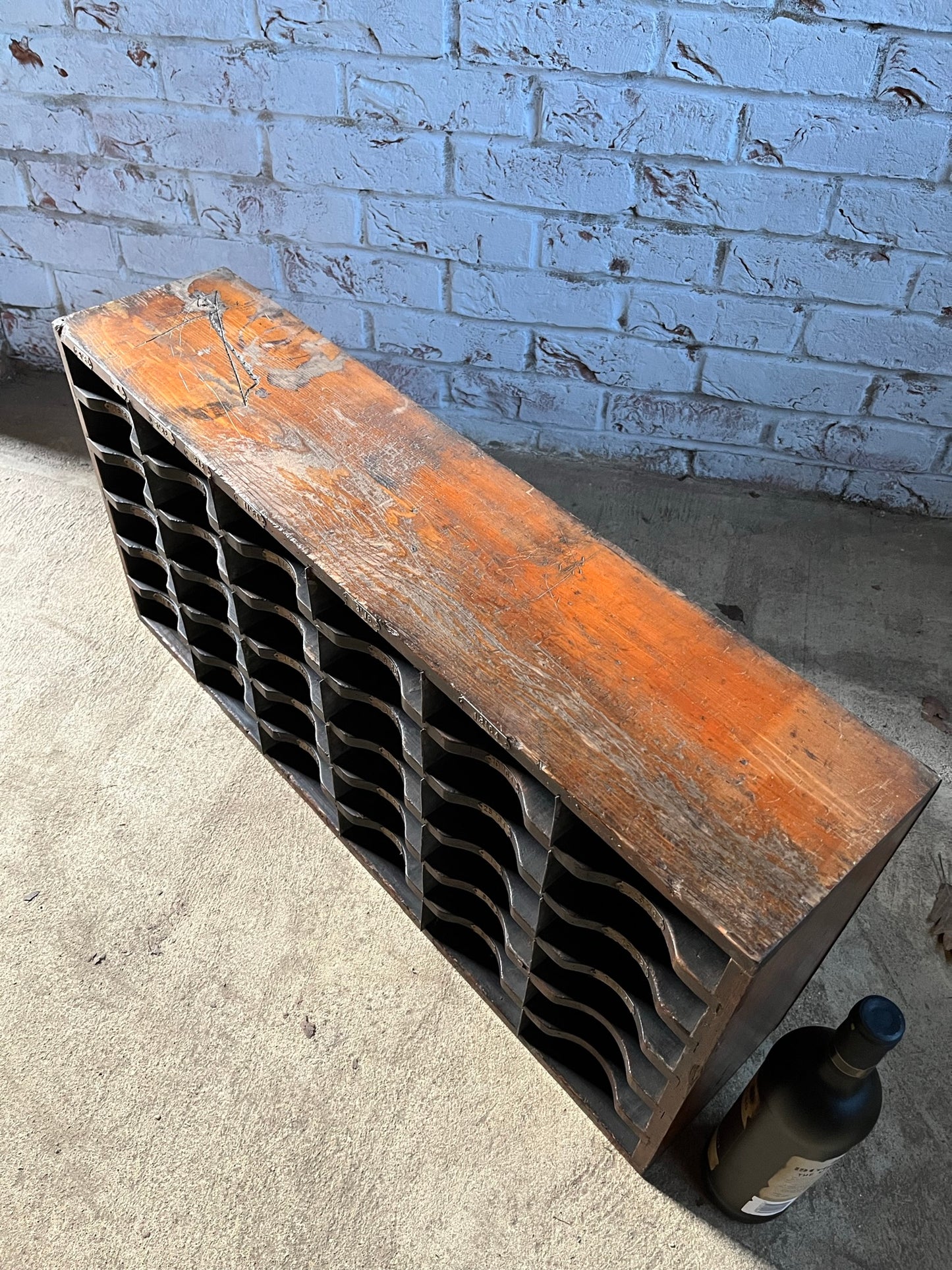 A vintage pine and metal industrial pigeon hole cabinet.