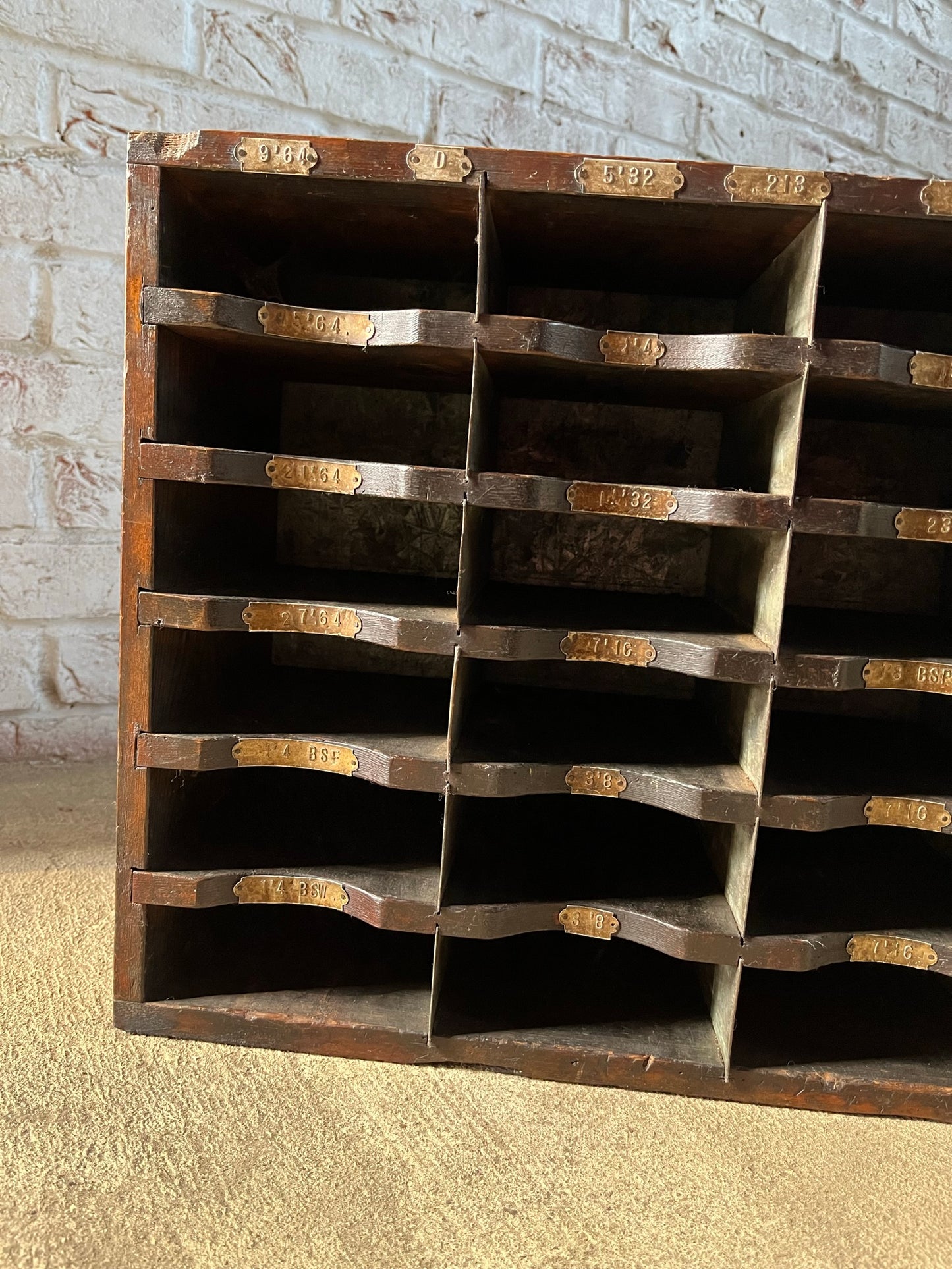 A vintage pine and metal industrial pigeon hole cabinet.