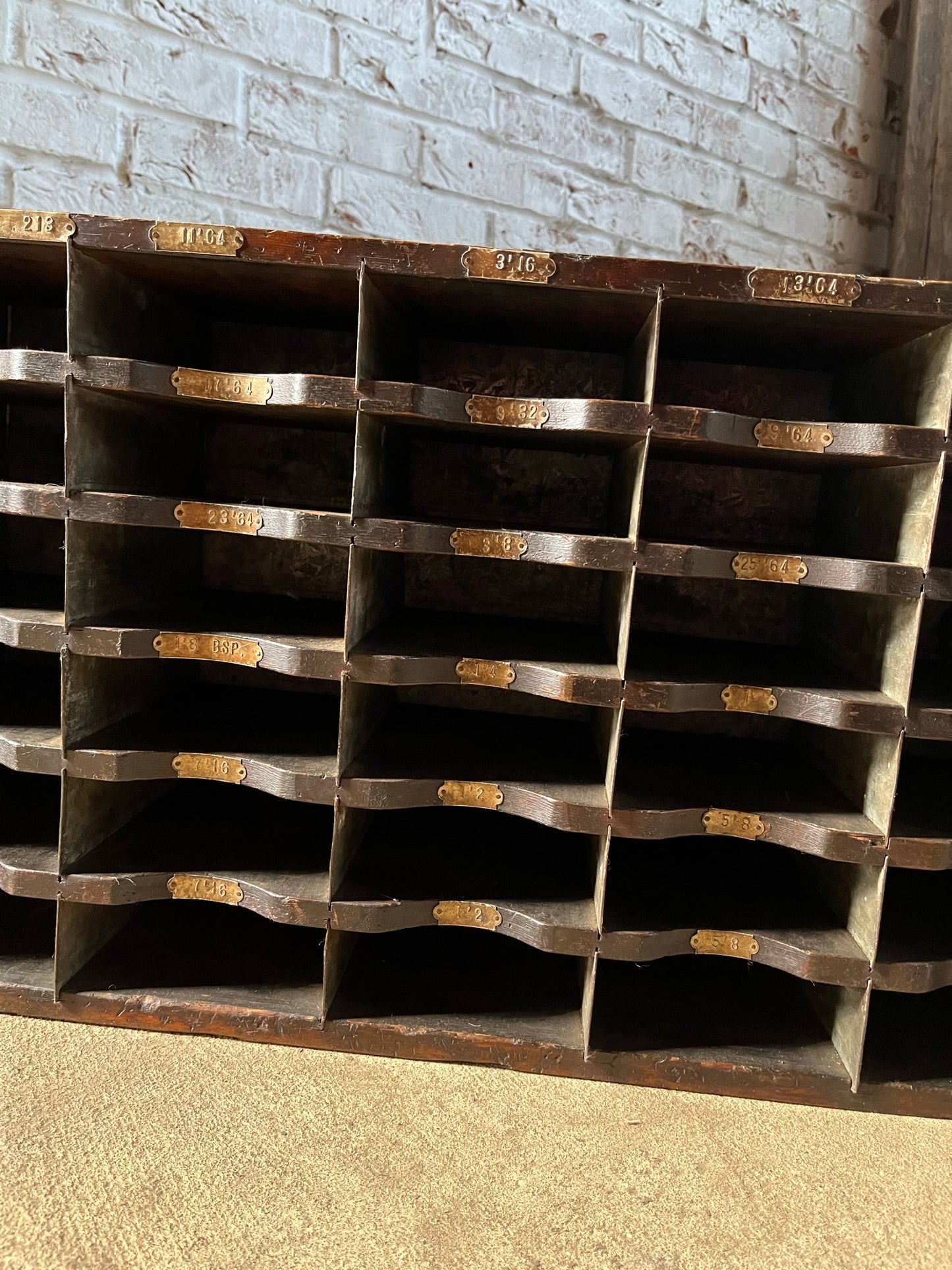A vintage pine and metal industrial pigeon hole cabinet.
