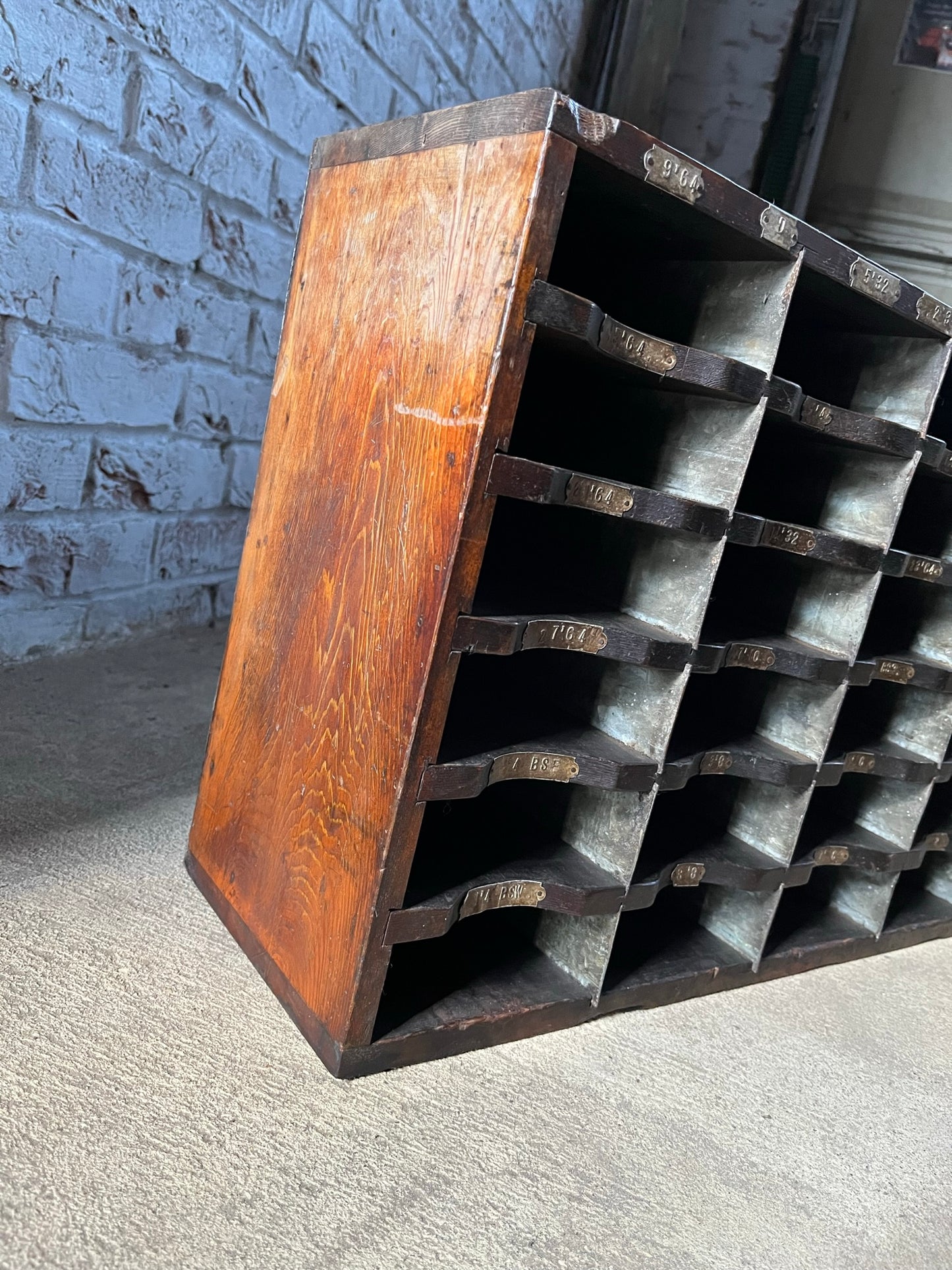 A vintage pine and metal industrial pigeon hole cabinet.