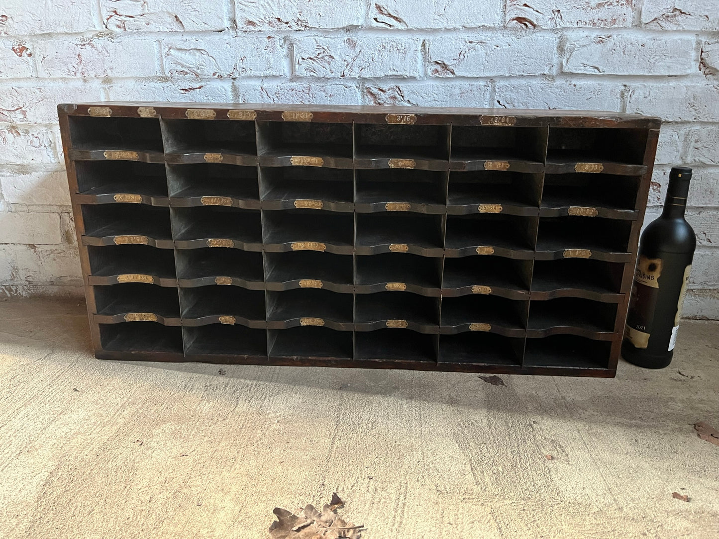 A vintage pine and metal industrial pigeon hole cabinet.