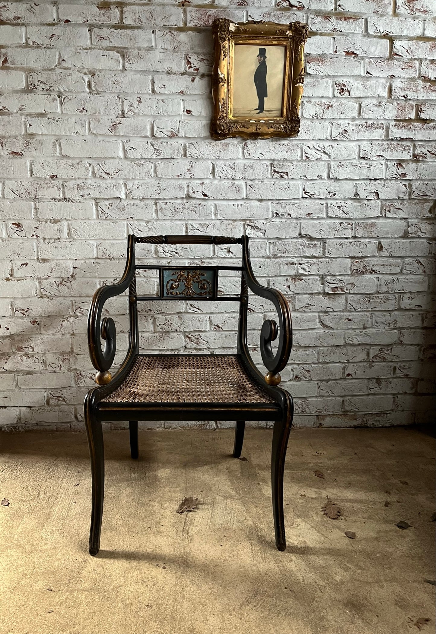 Regency ebonised and painted armchair.