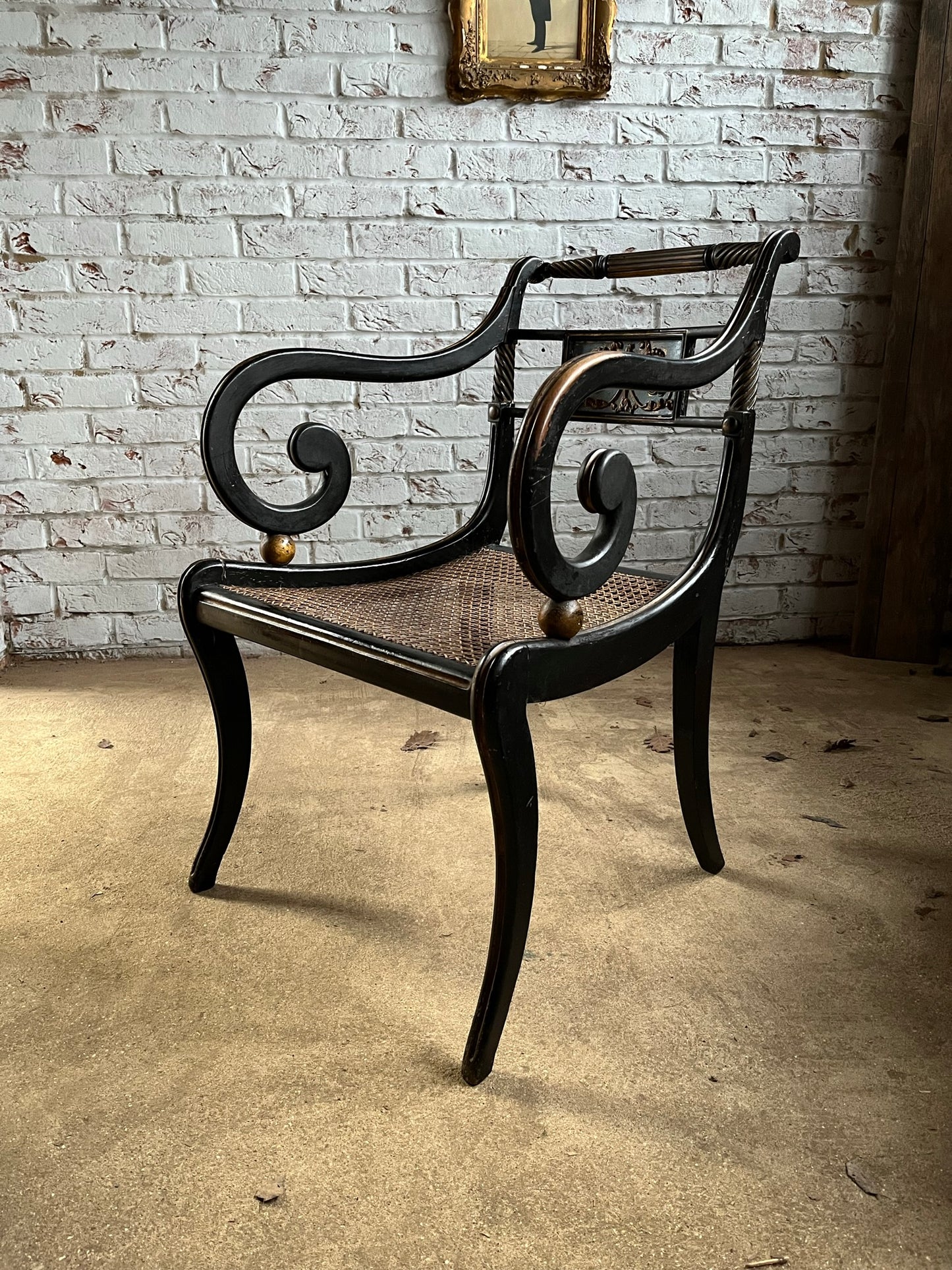 Regency ebonised and painted armchair.