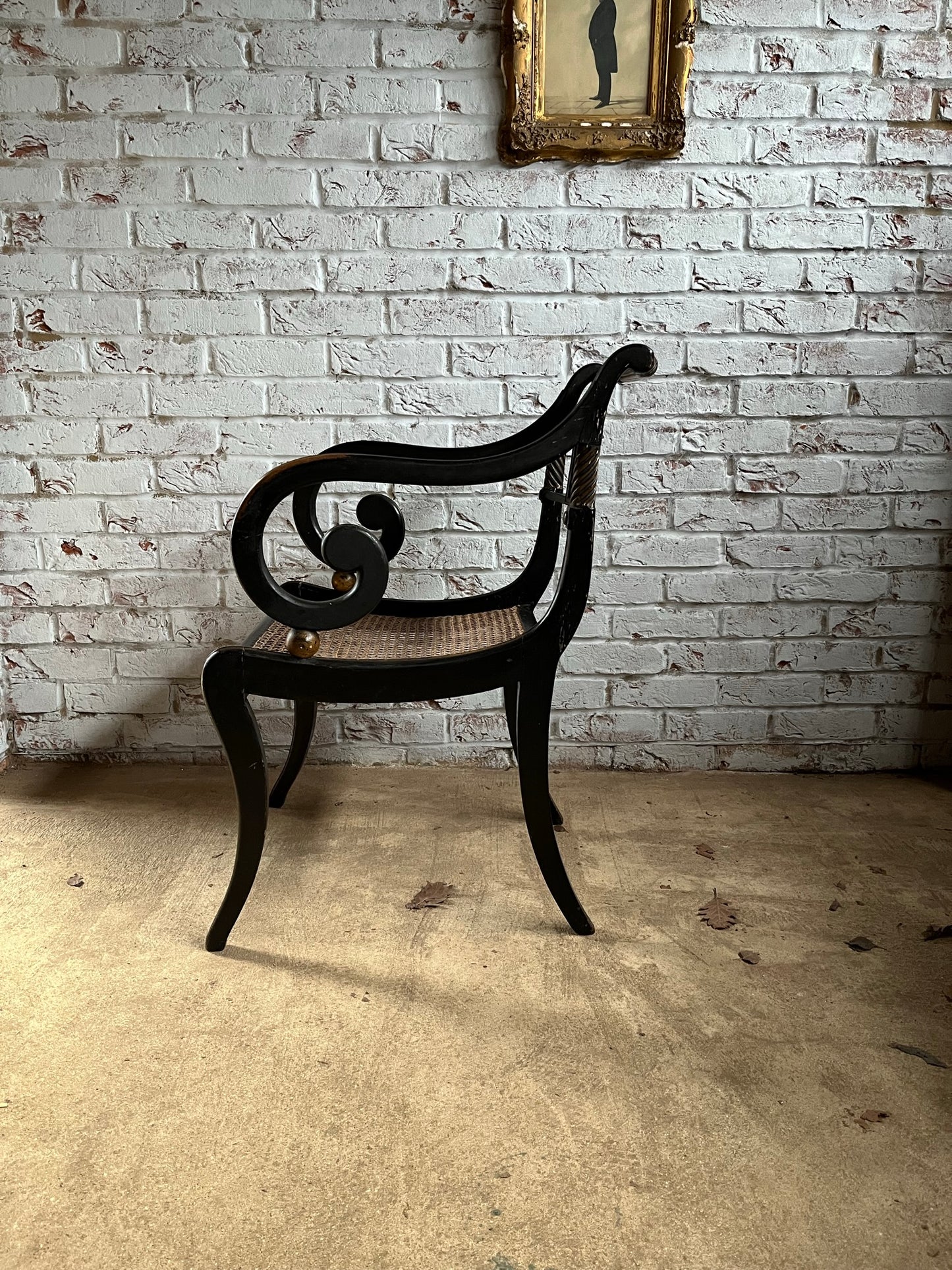 Regency ebonised and painted armchair.
