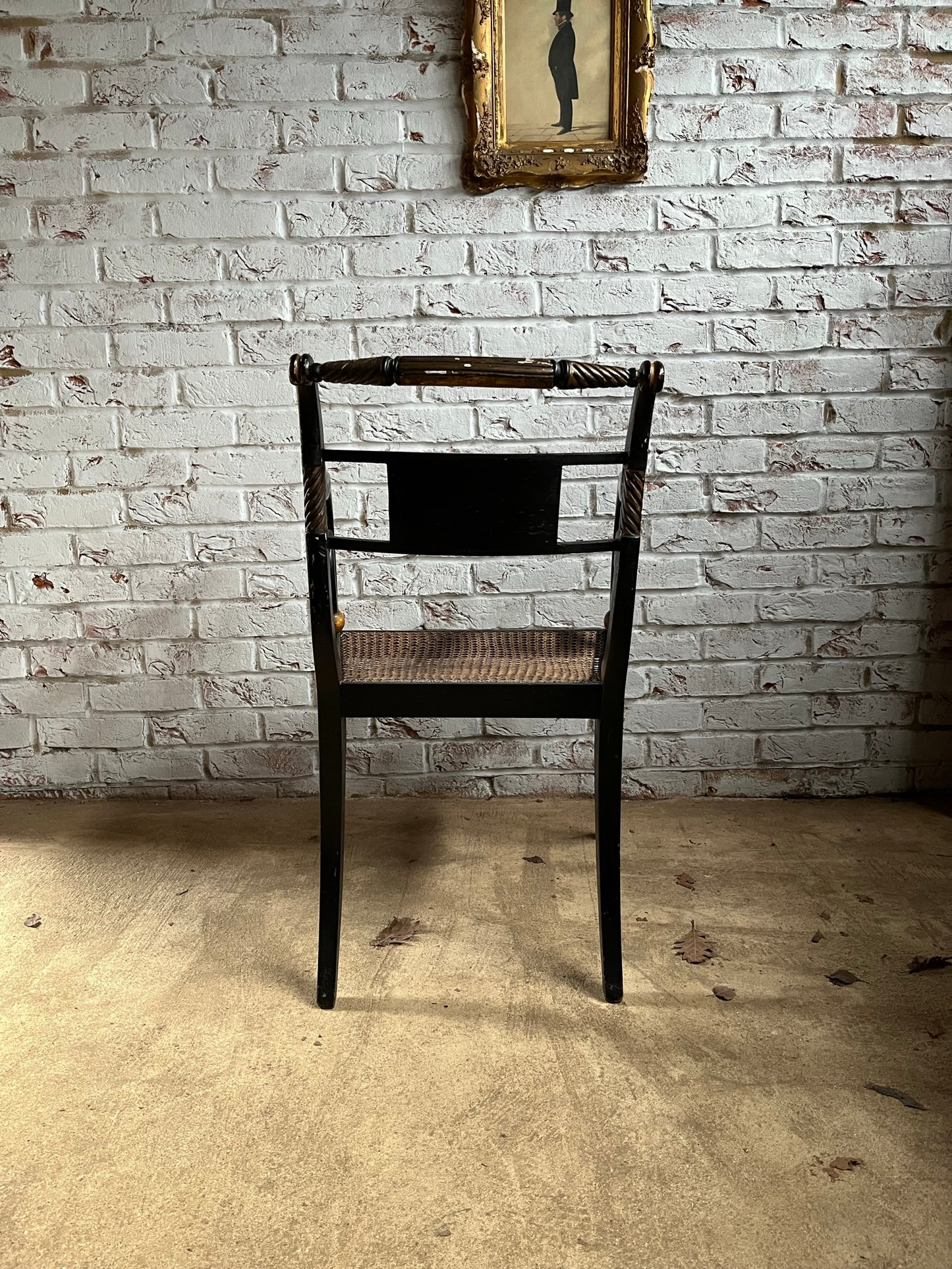 Regency ebonised and painted armchair.
