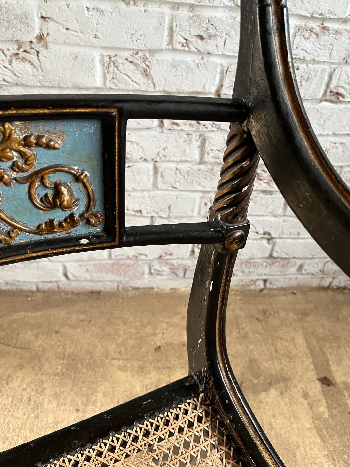 Regency ebonised and painted armchair.
