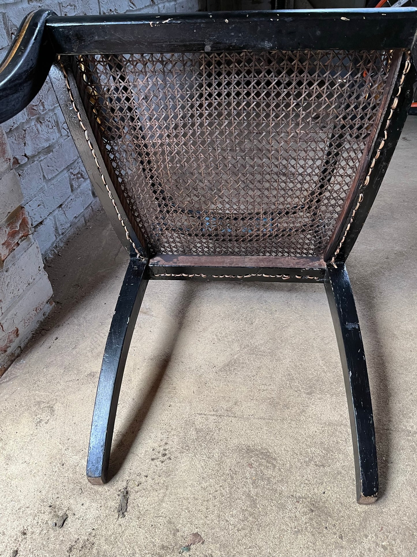 Regency ebonised and painted armchair.