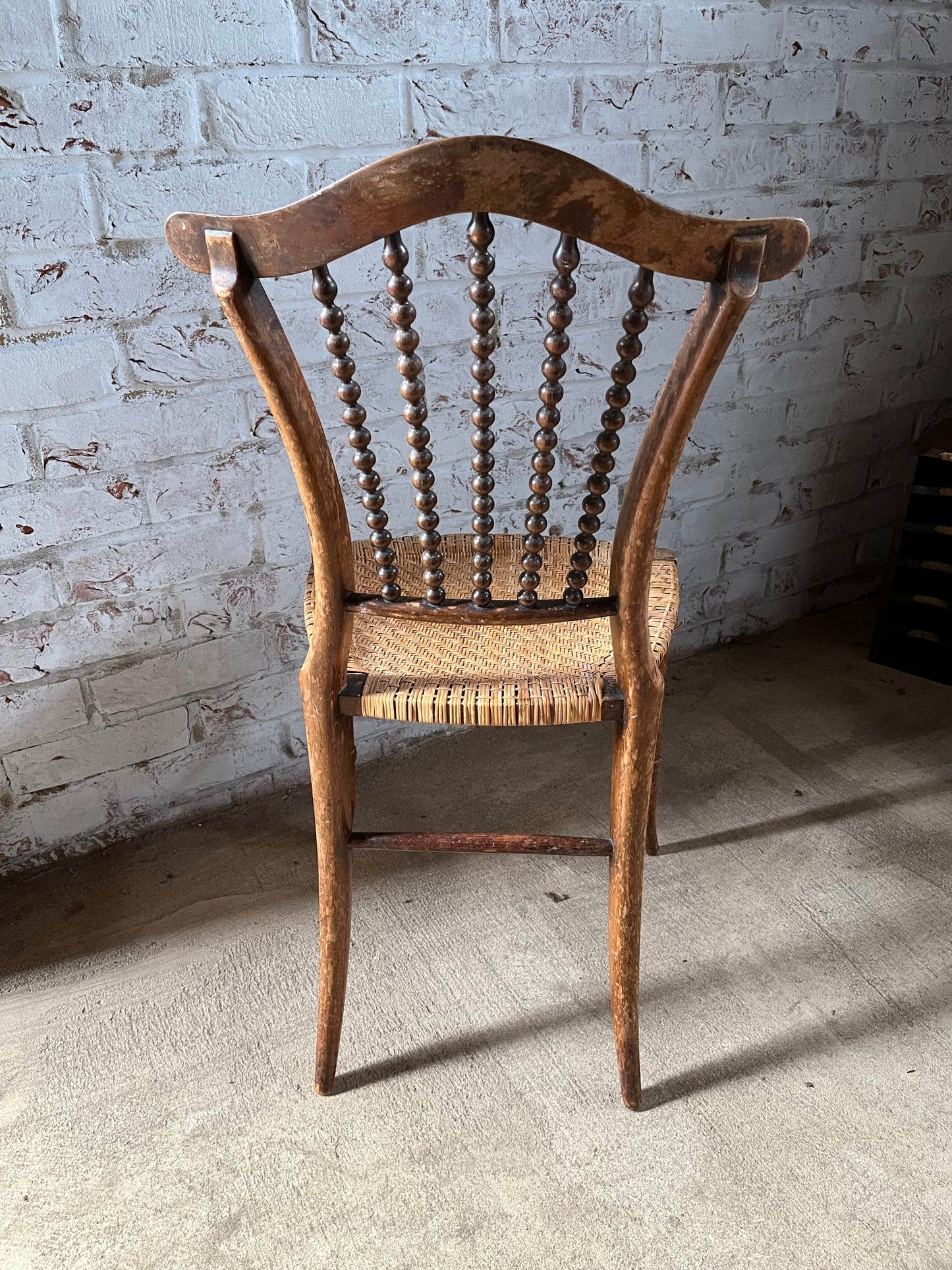 Chair with lyre-shaped back and bobbin back splat.
